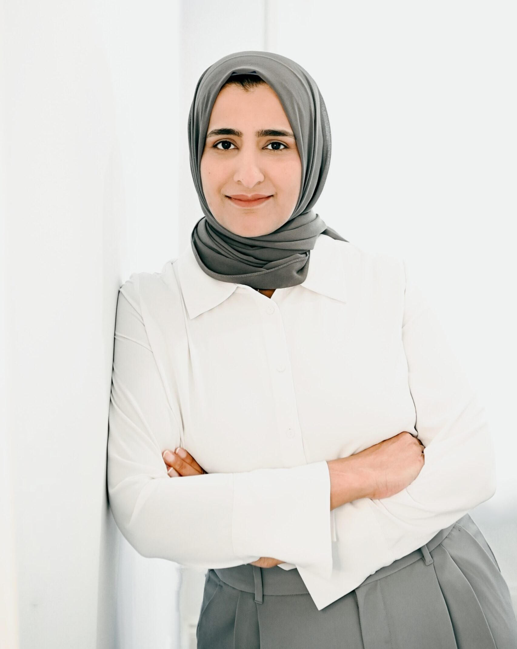 Portrait of Benazir, middle eastern woman wearing white blouse and grey hijab